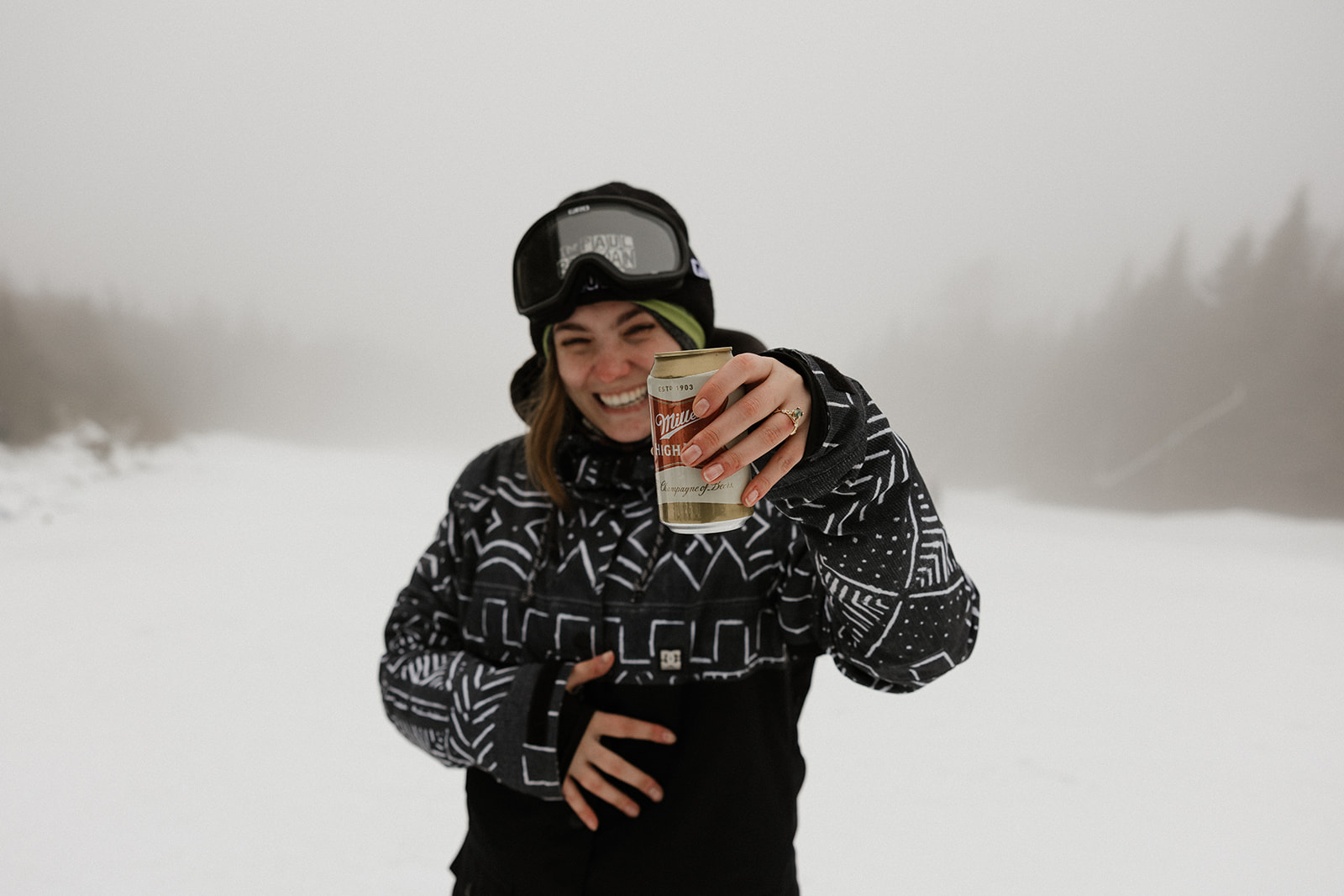 bride shows off her new ring as shes celebrates with a beer!