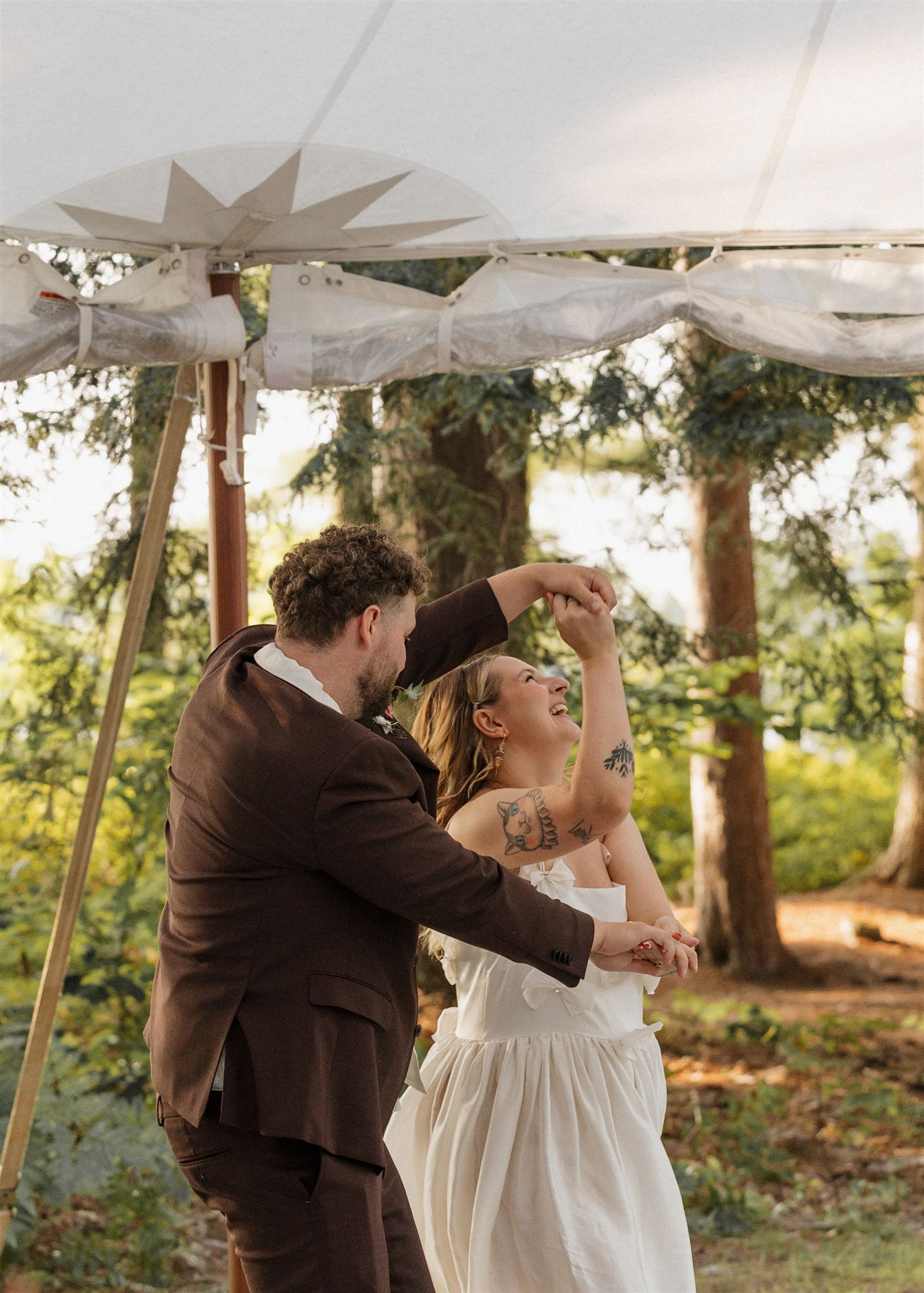 bride and groom share a laughter filled dance