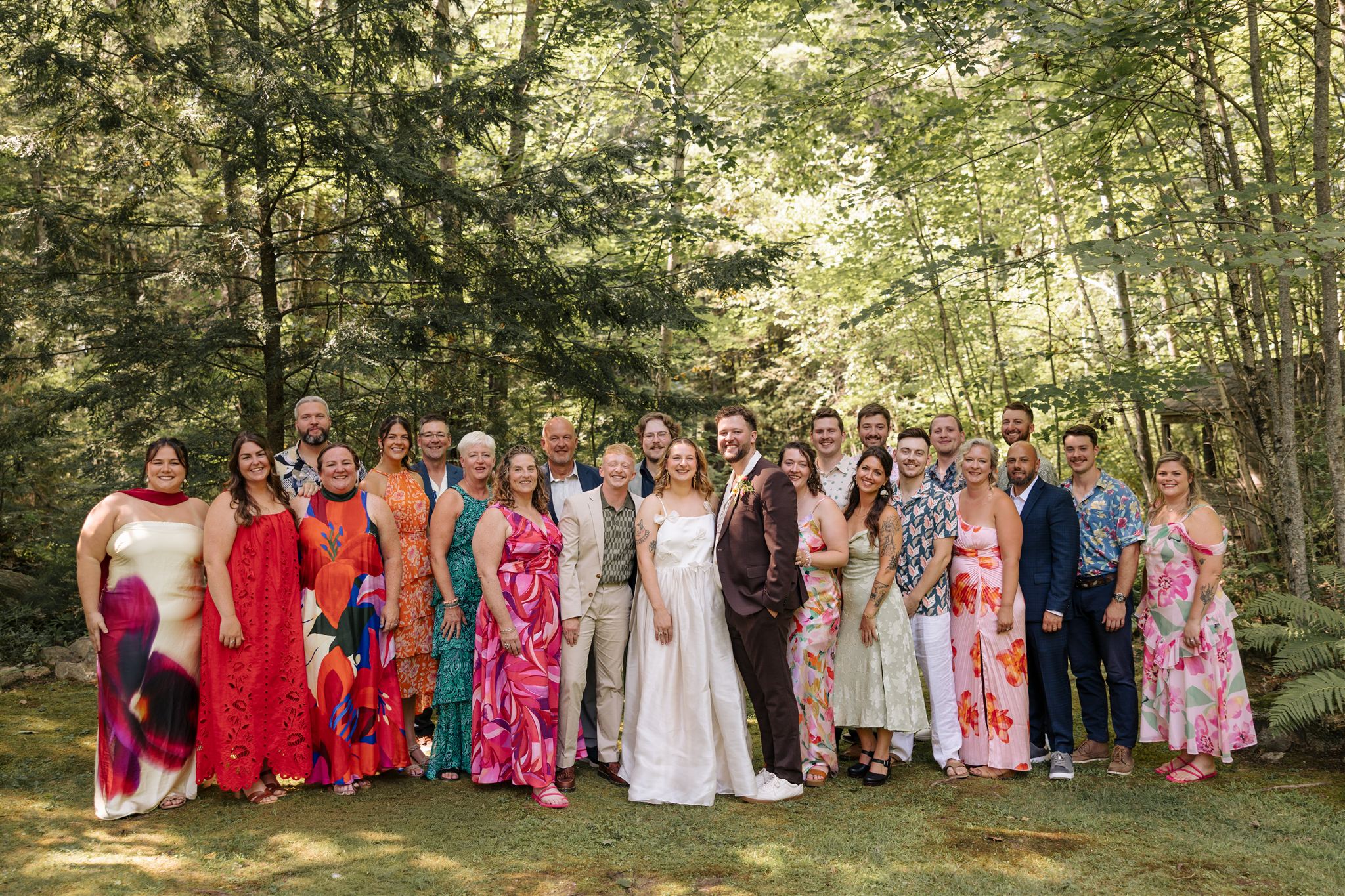 bride and groom pose with with their families