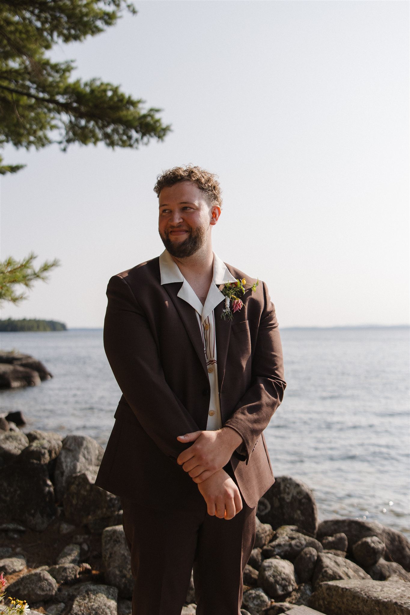 groom eagerly awaits his bride at the ceremony site