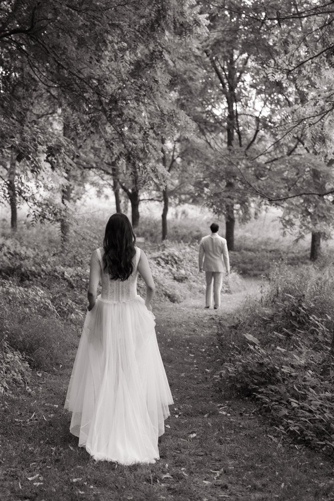bride approaches the groom to start their first look session