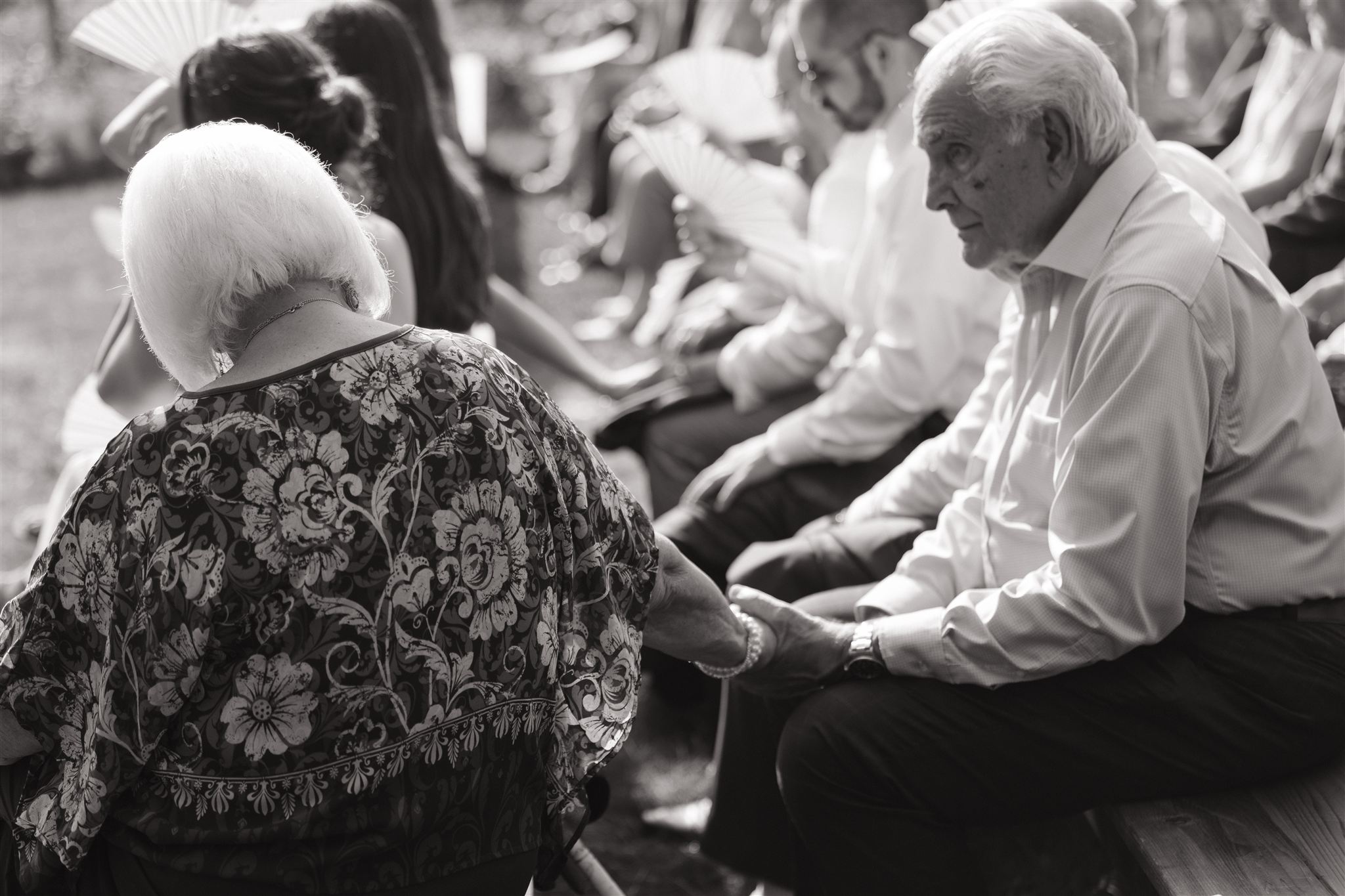 grandparents hold hands during the beautiful wedding ceremony