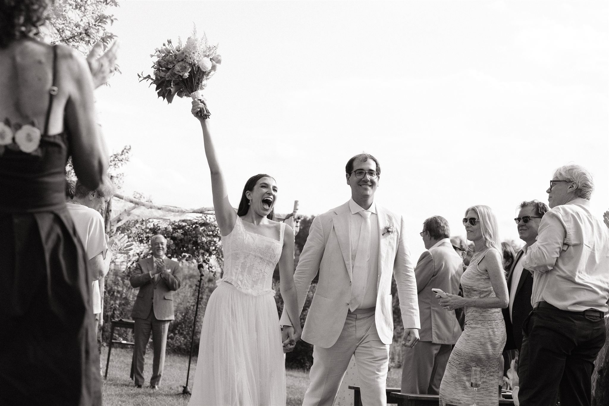 stunning bride and groom celebrate as they exit their Taconic Ridge wedding ceremony 