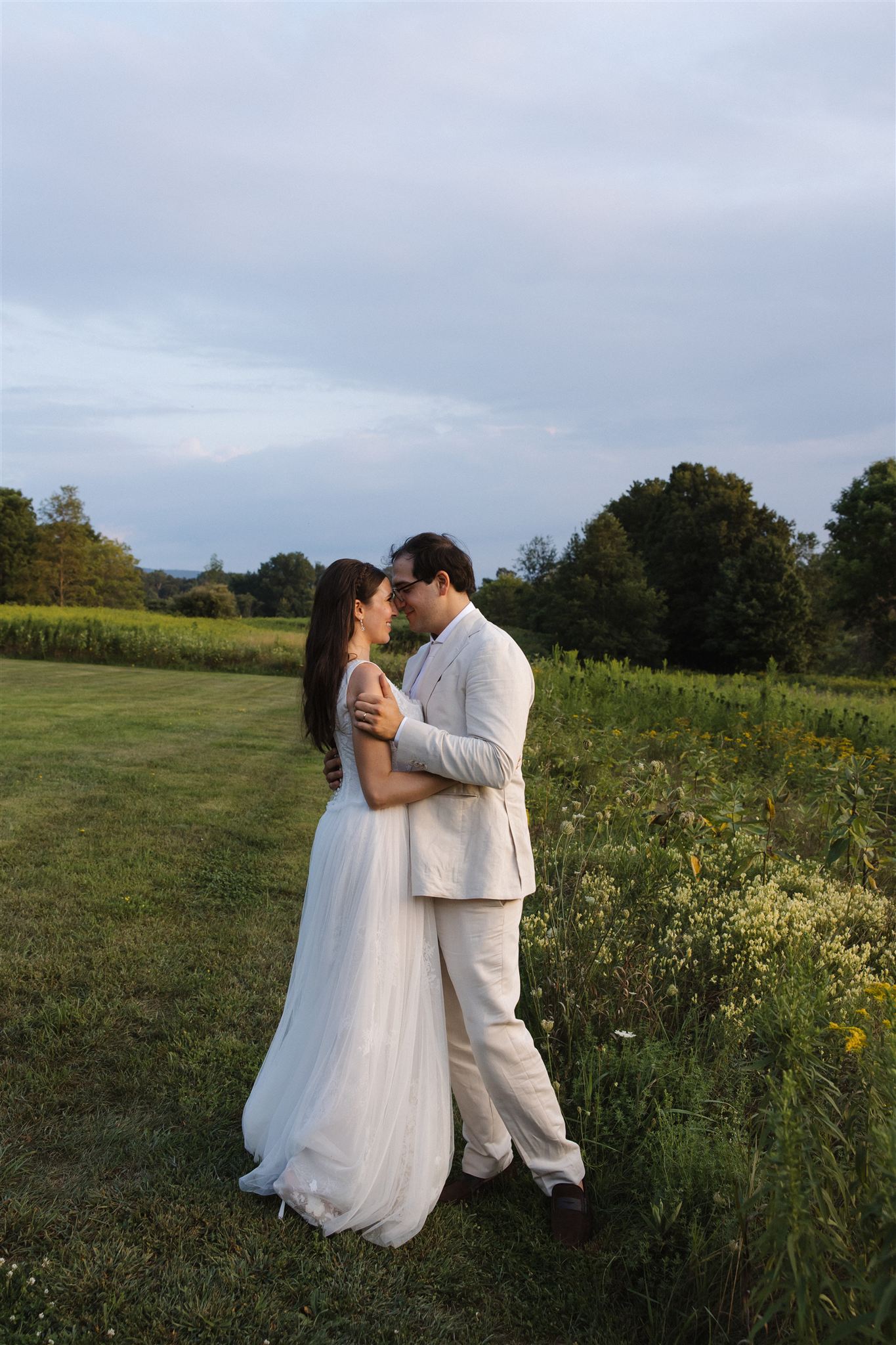 bride and groom share a first dance in the fields outside the stunning reception venue at Taconic Ridge in Upstate NY