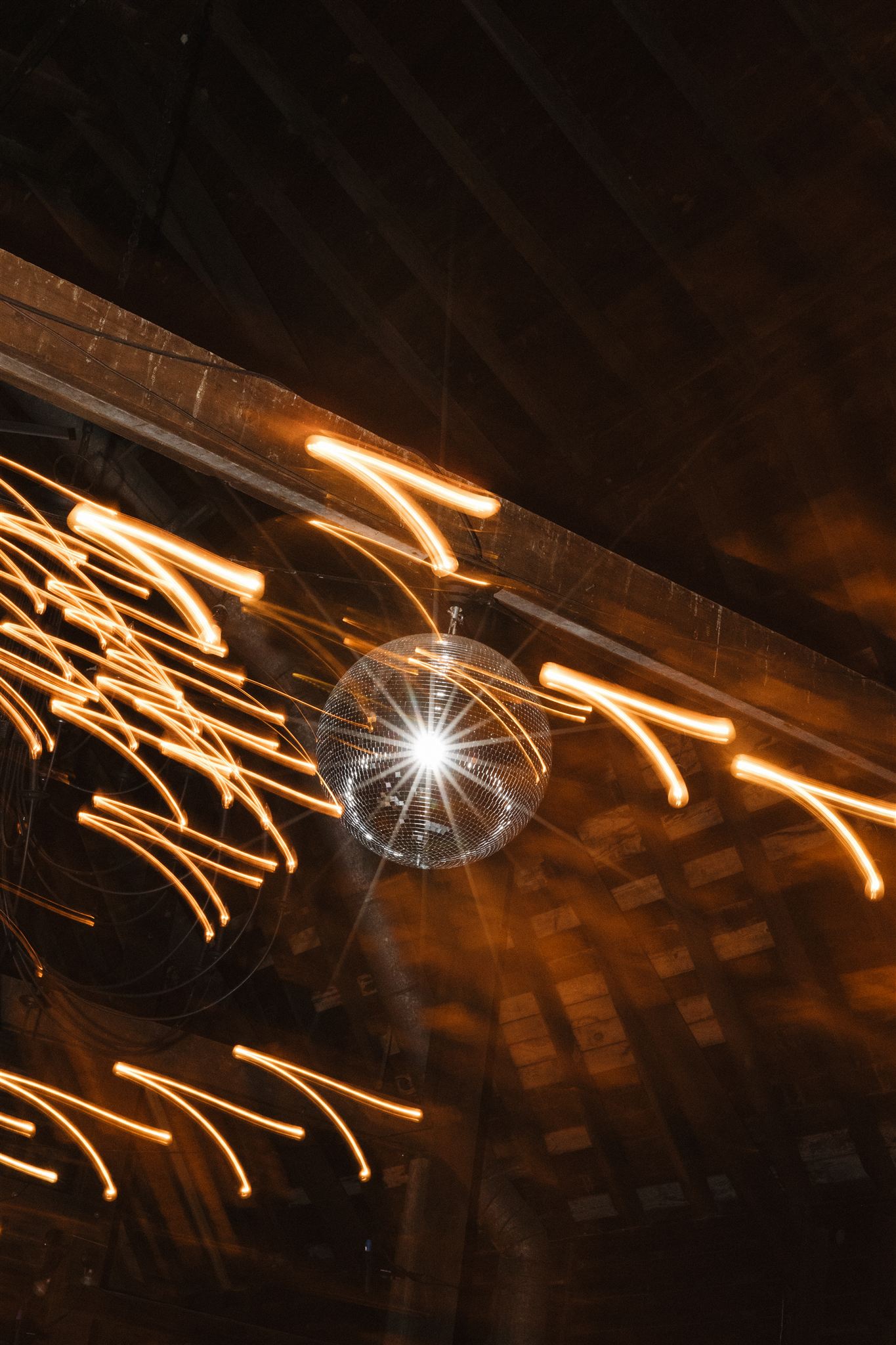 editorial style photo featuring light flashes and disco ball