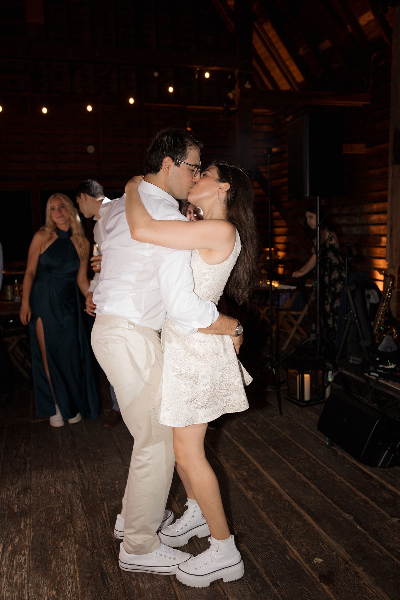 bride and groom share a kiss on the dance floor