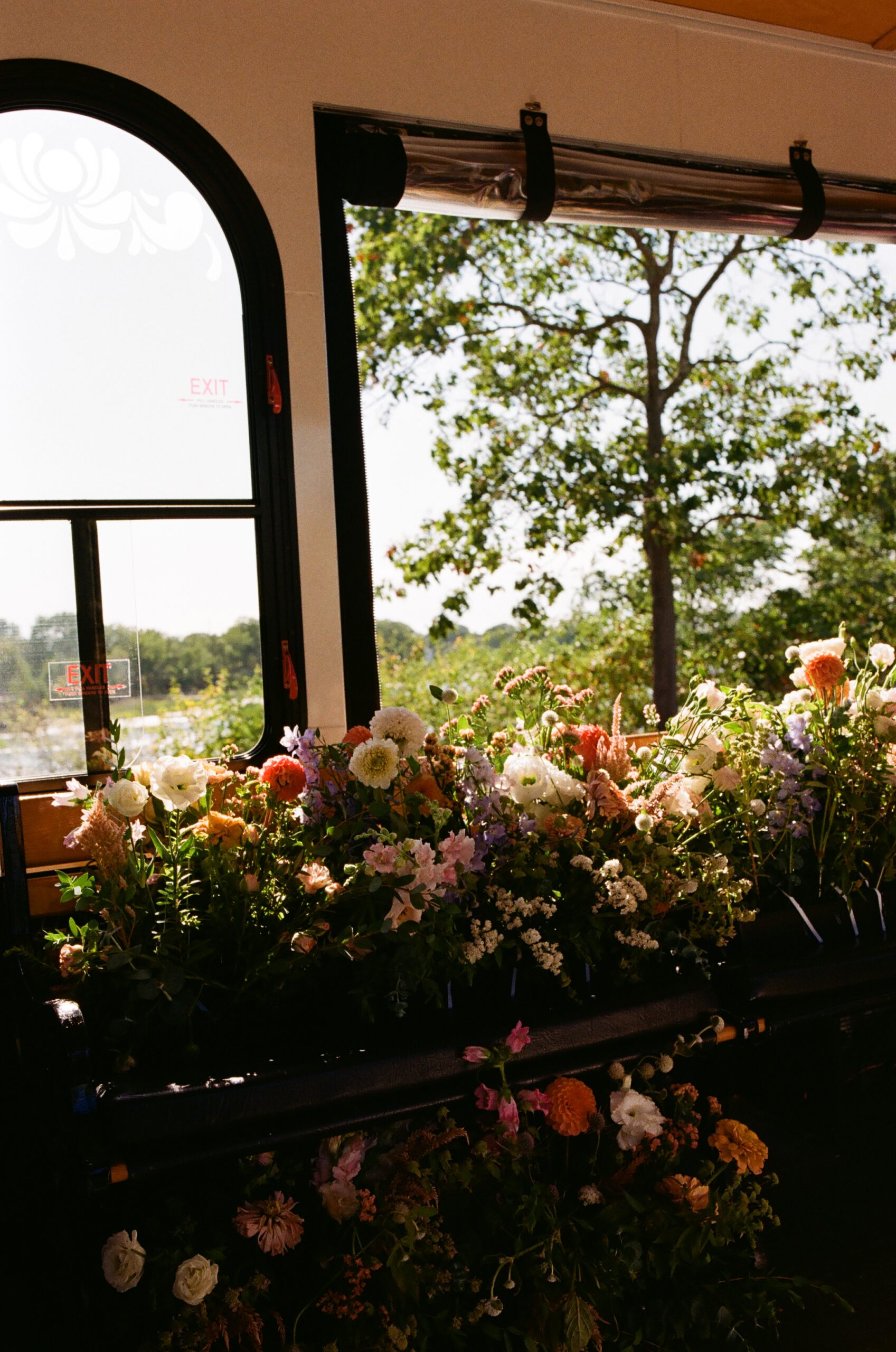 Wedding florals on a trolley in maine, captured on film by erica warren