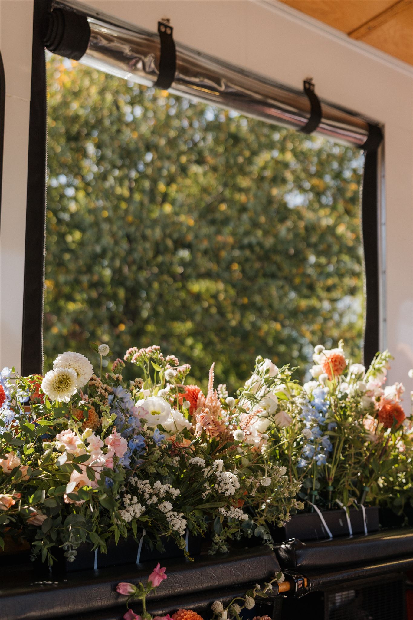 wedding florals sit in the window sill