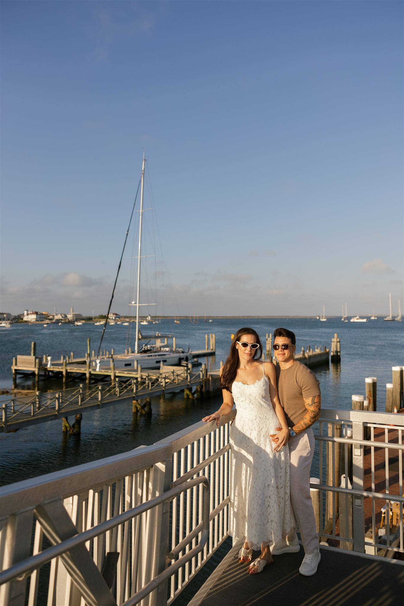stunning bride and groom pose by the waterfront during their wedding retreat
