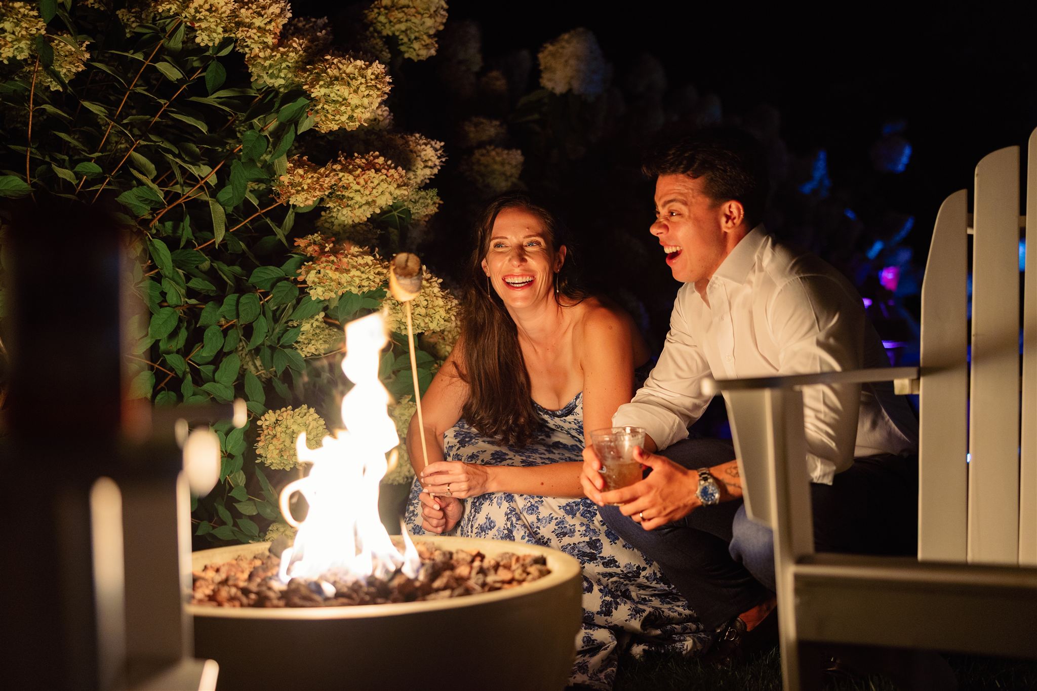guests toast marshmellows by the fire