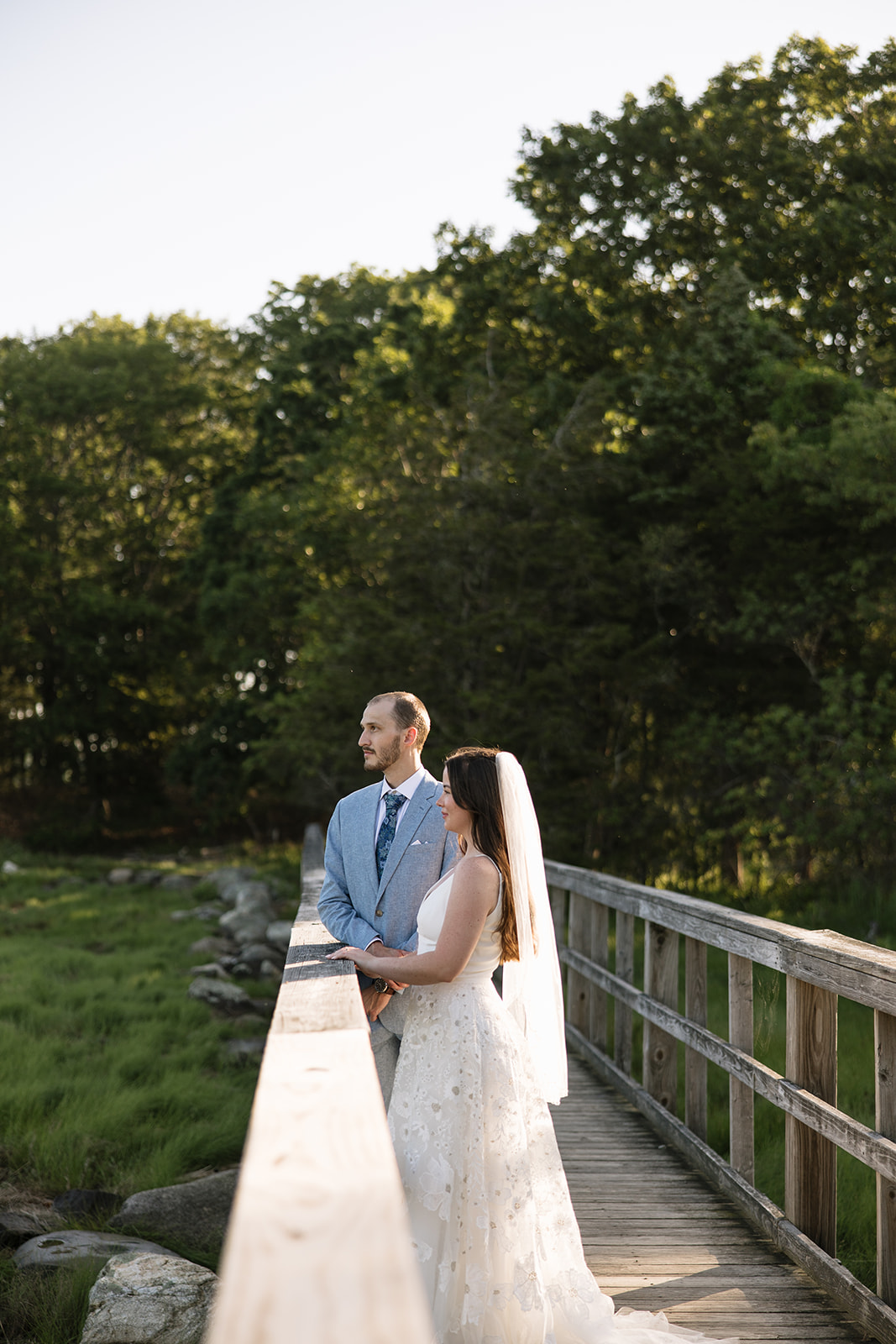bride and groom talk on the boardwalk after their New Hampshire elopement