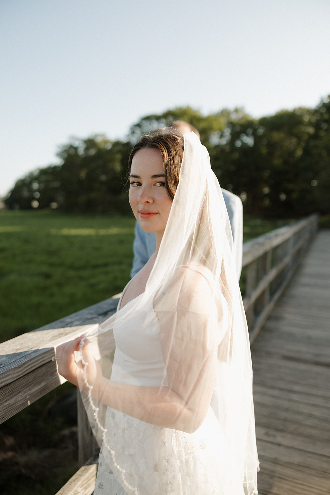 bride poses for a photo on the boardwalk