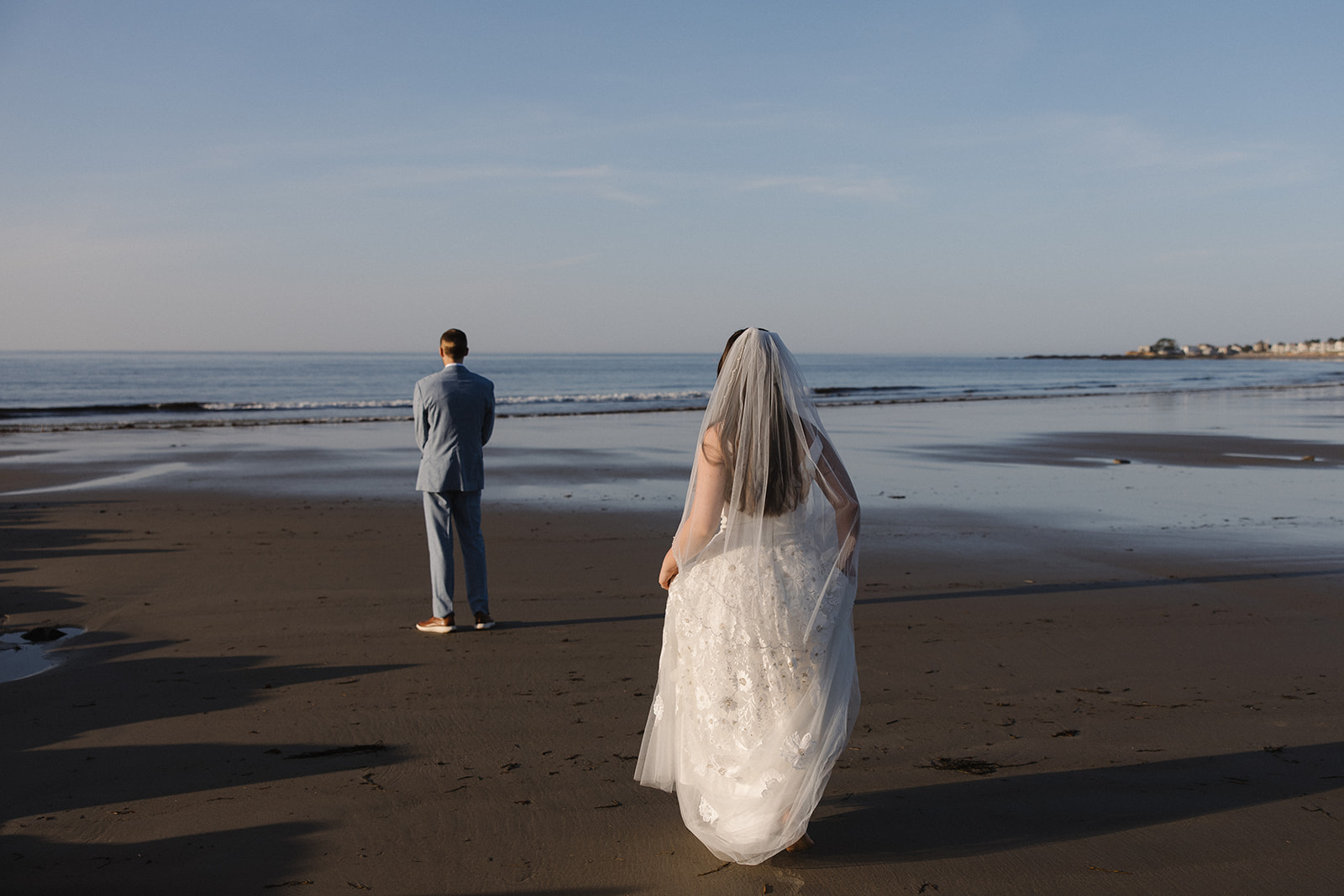 bride walks towards her soon to be husband on the beach before their Fuller Gardens elopement day
