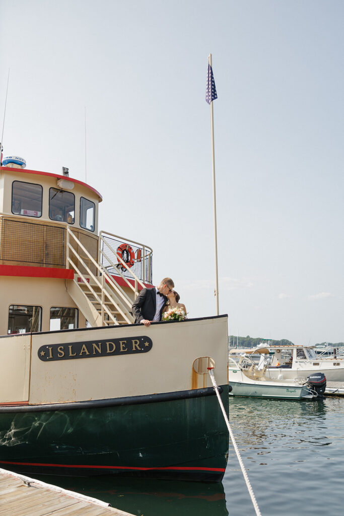 couple share romantic moments on a boat, a very unique Maine wedding venue!