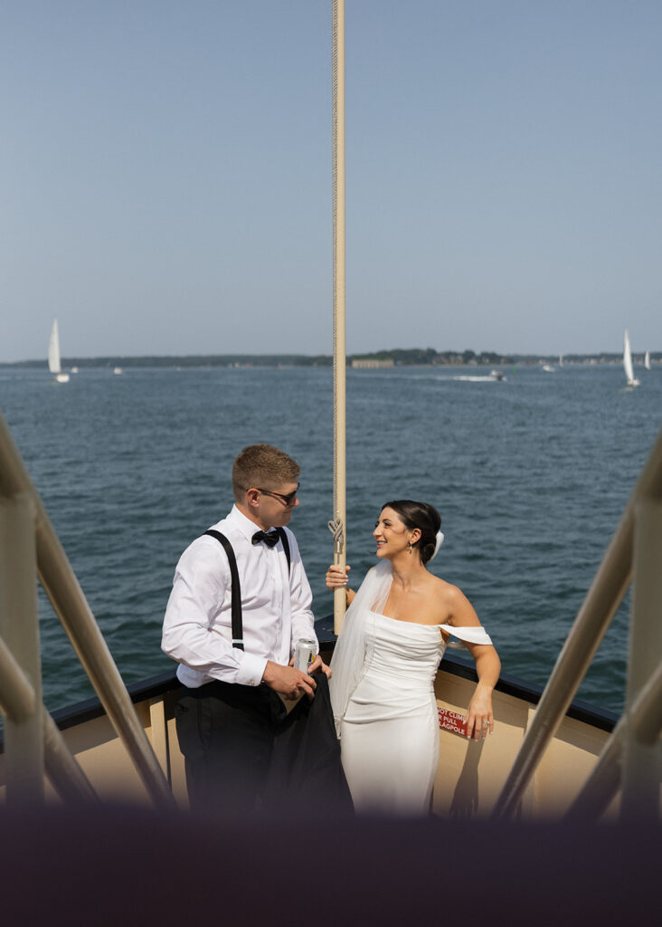 couple share romantic moments on a boat, a very unique Maine wedding venue!