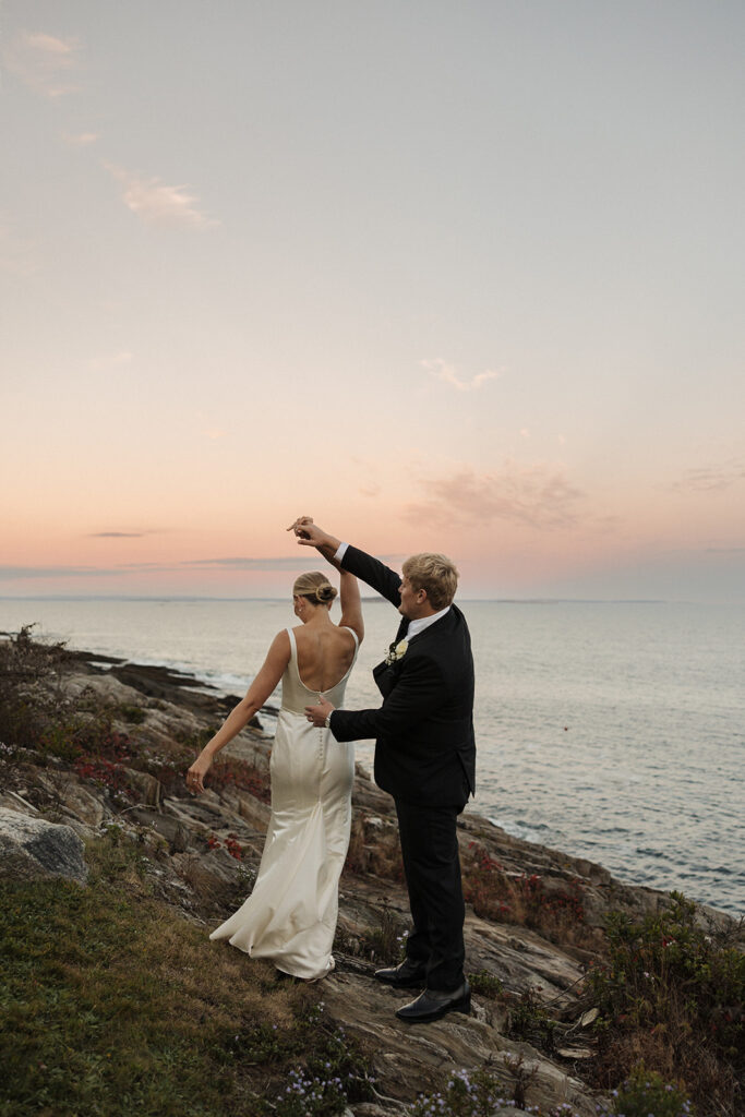beautiful bride and groom share romantic moments as the get married by the Maine coast