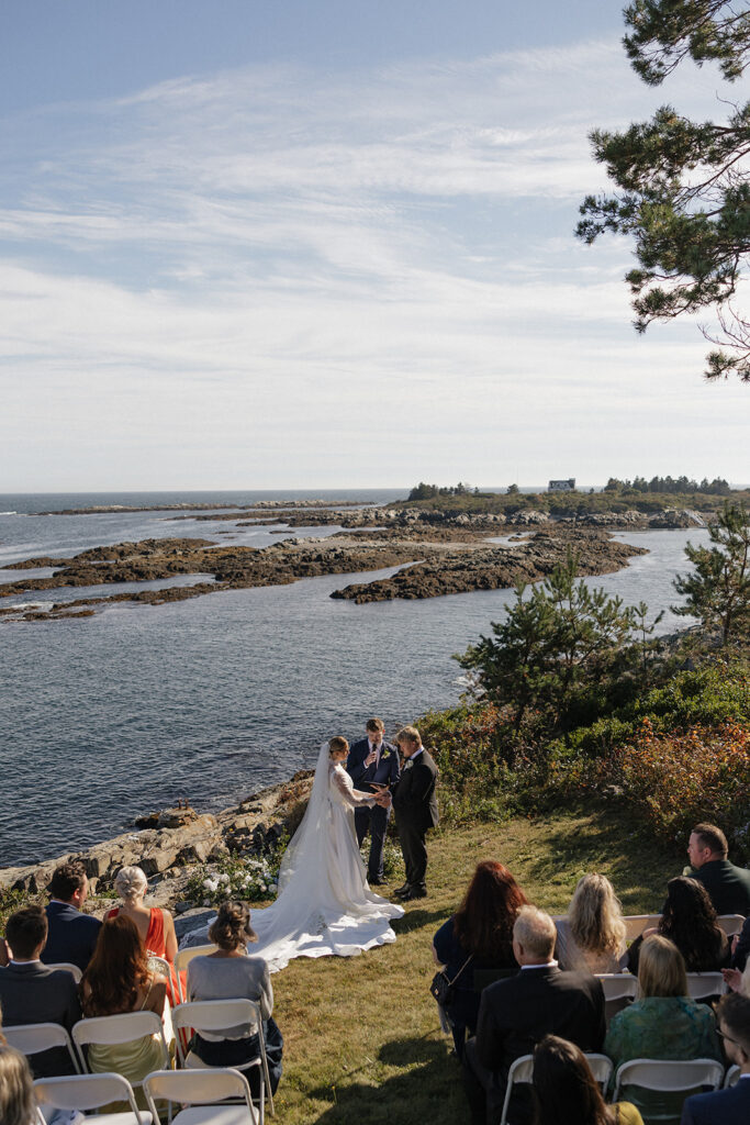 beautiful bride and groom share romantic moments as the get married by the Maine coast