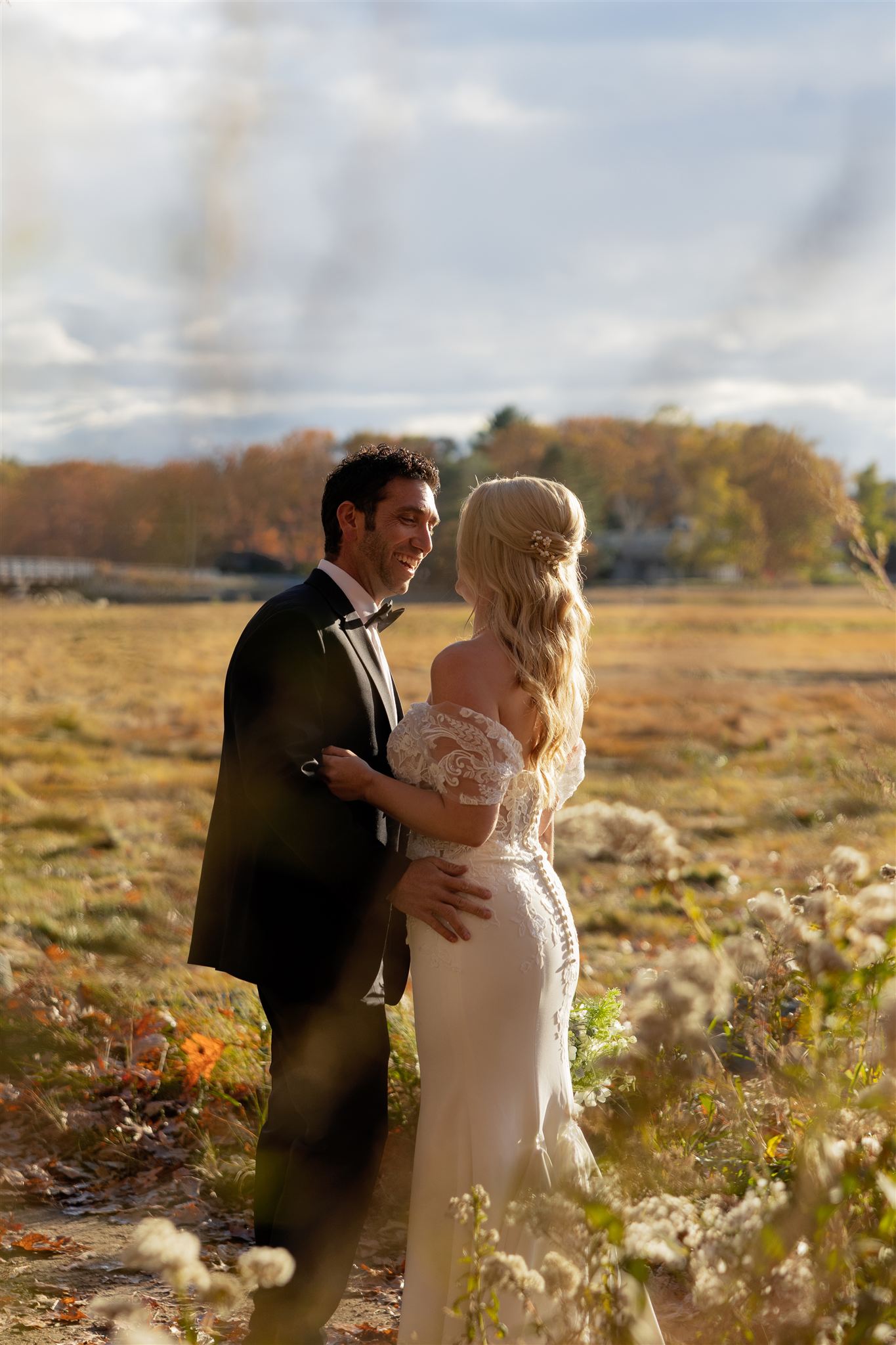 bride and groom share a smile and laugh during their post wedding photoshoot