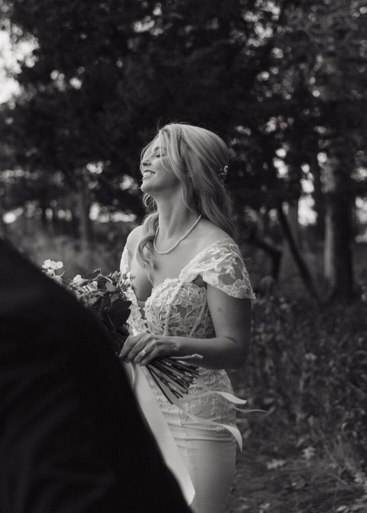 documentary style photo of the bride as she laughs at her groom