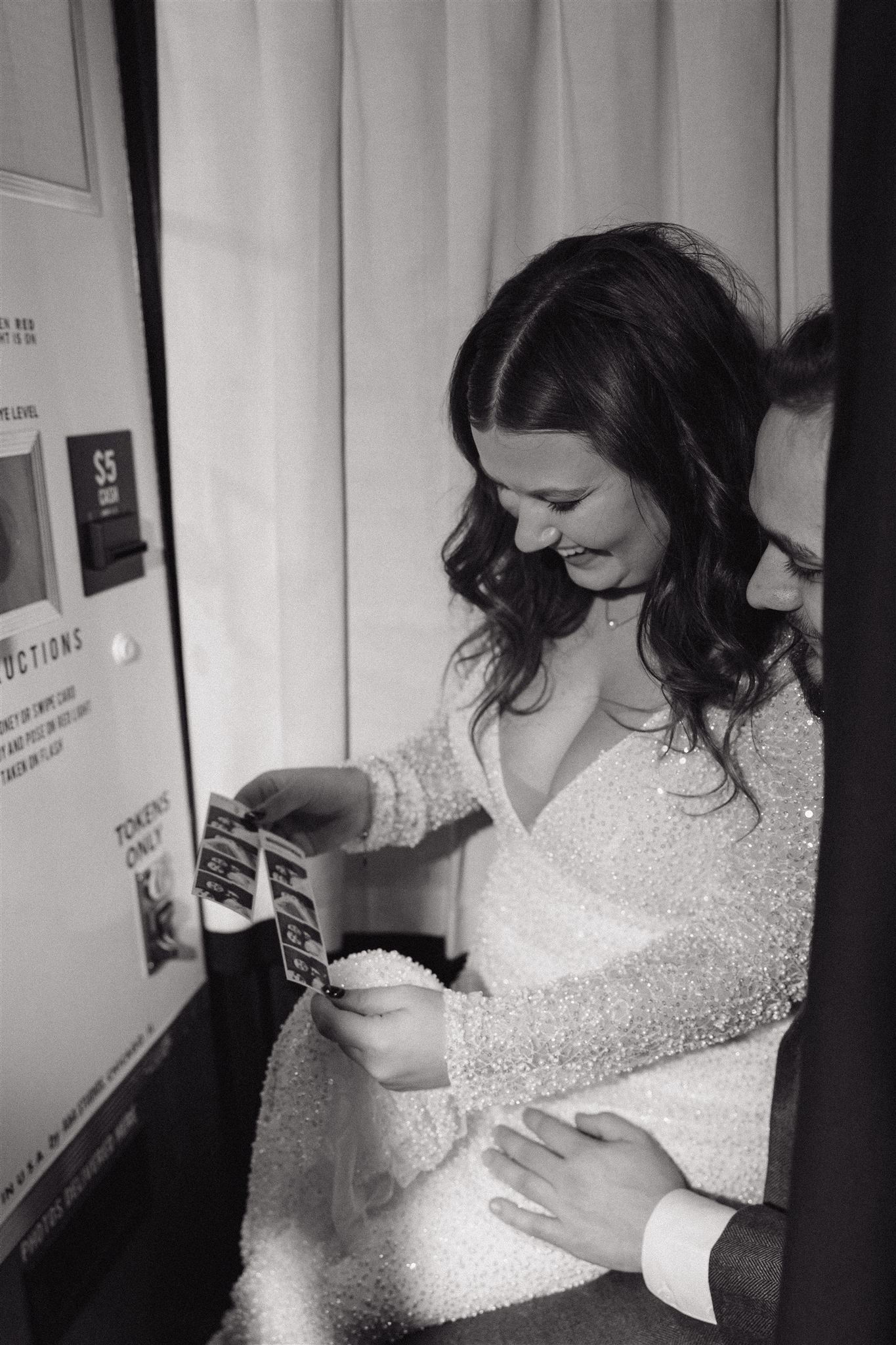 bride and groom laugh and share intimate moments in the photo booth 