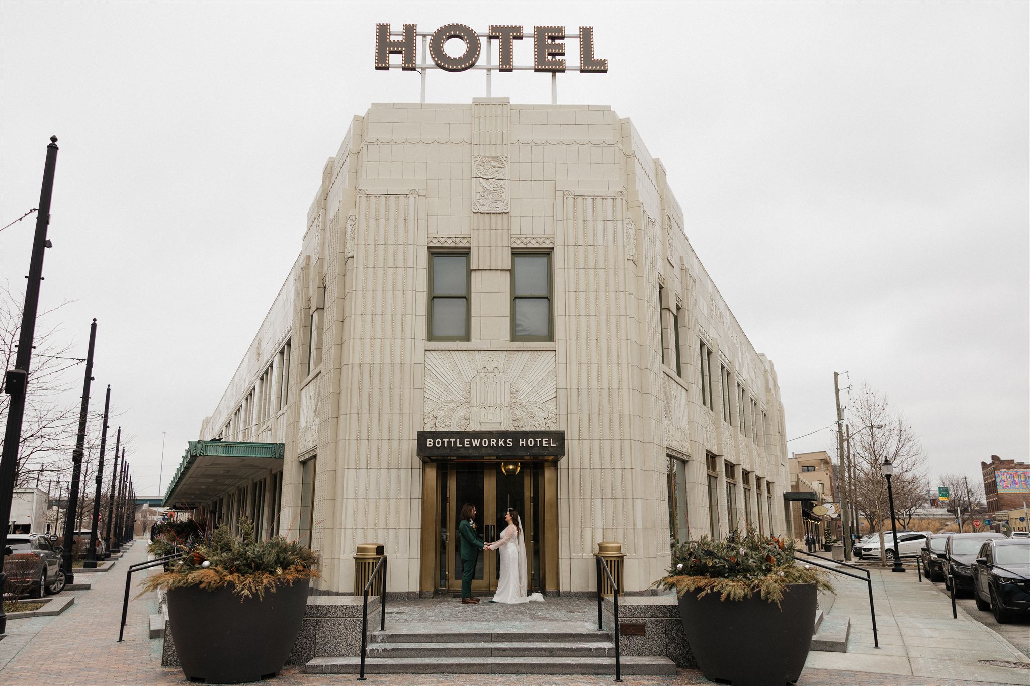 stunning couple hold hands in front of the beautiful bottleworks in Indianapolis a perfect way to make your elopement special