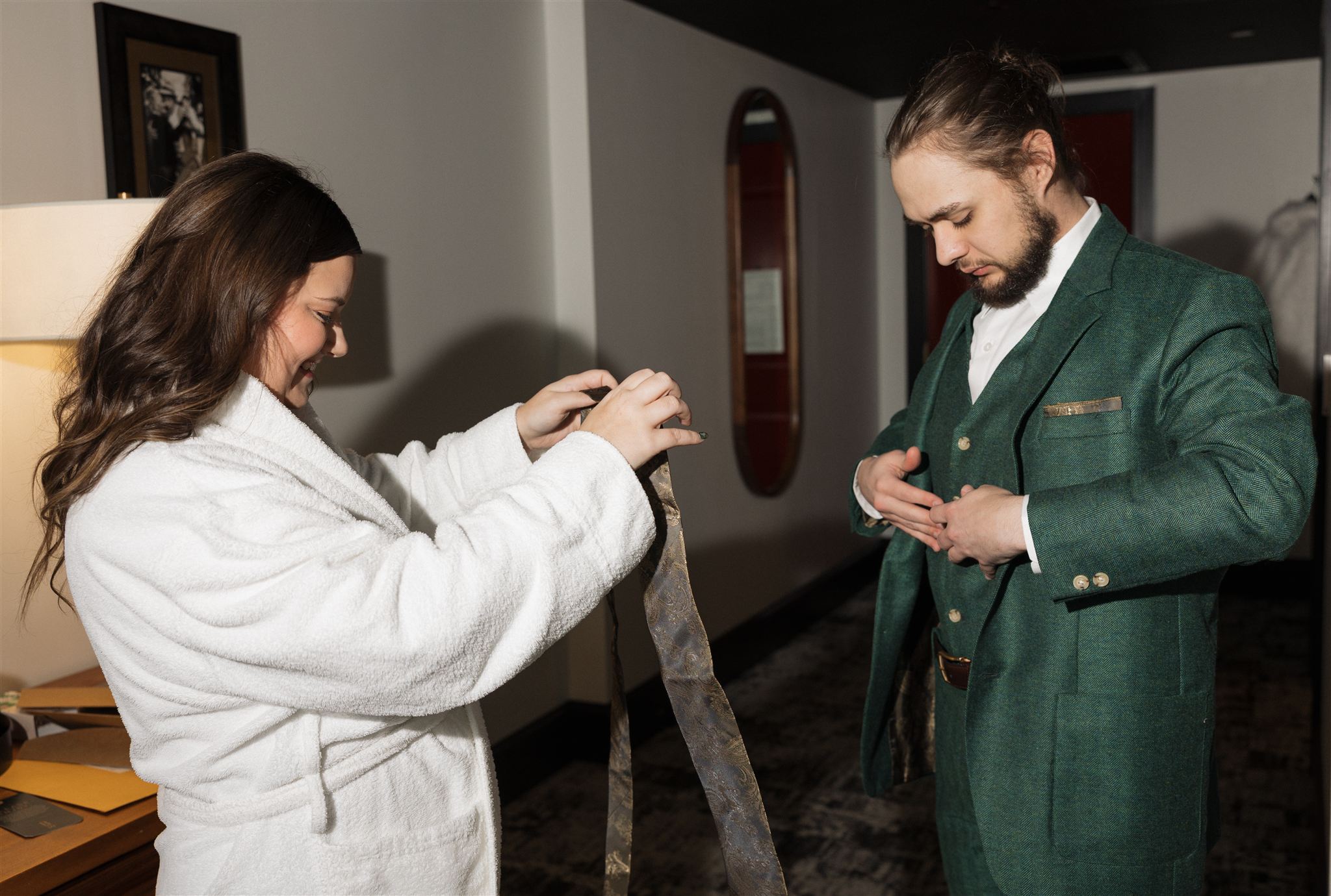 bride and groom get ready together in their hotel room a unique way to make your elopement special