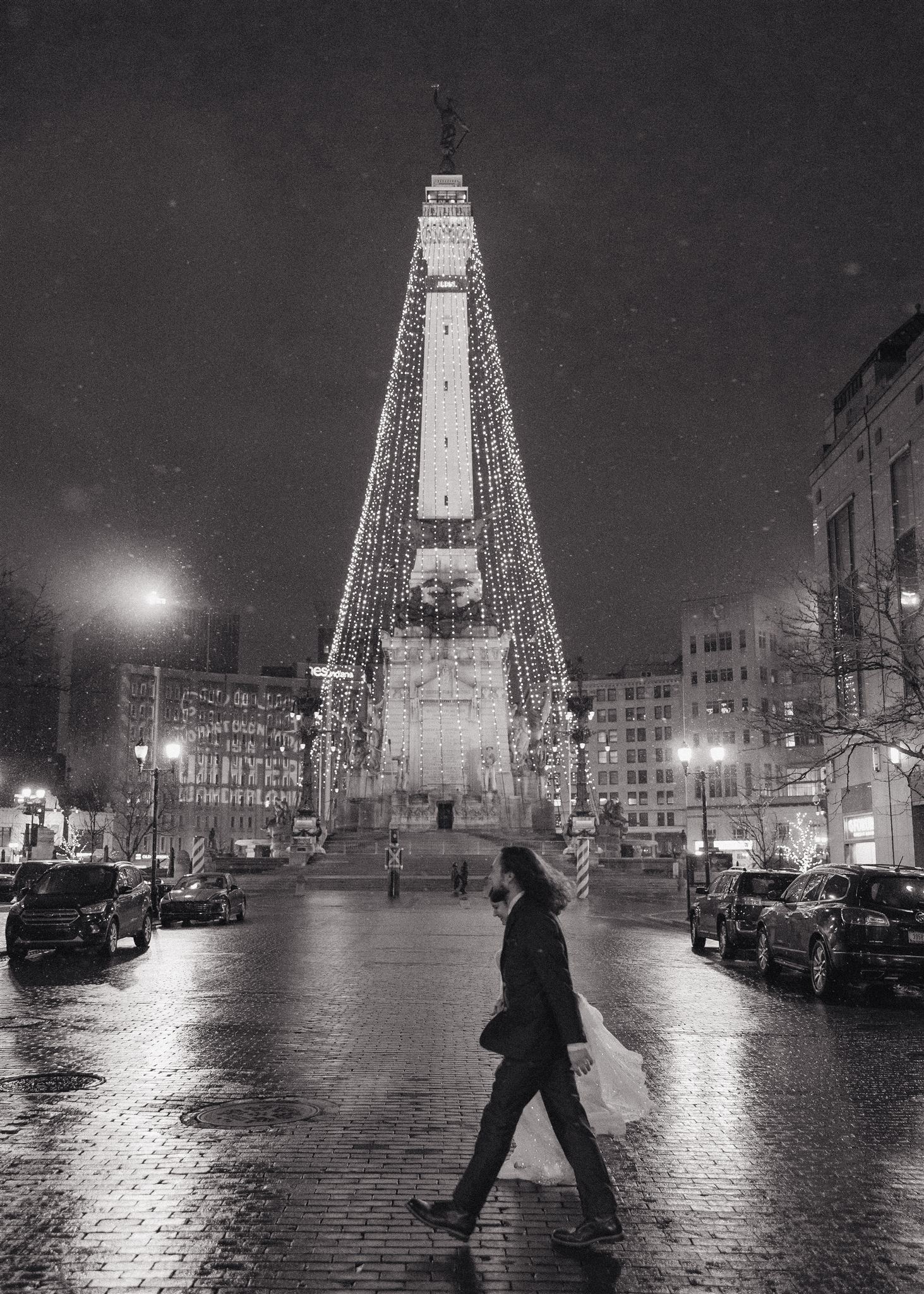 bride and groom walk around monument circle