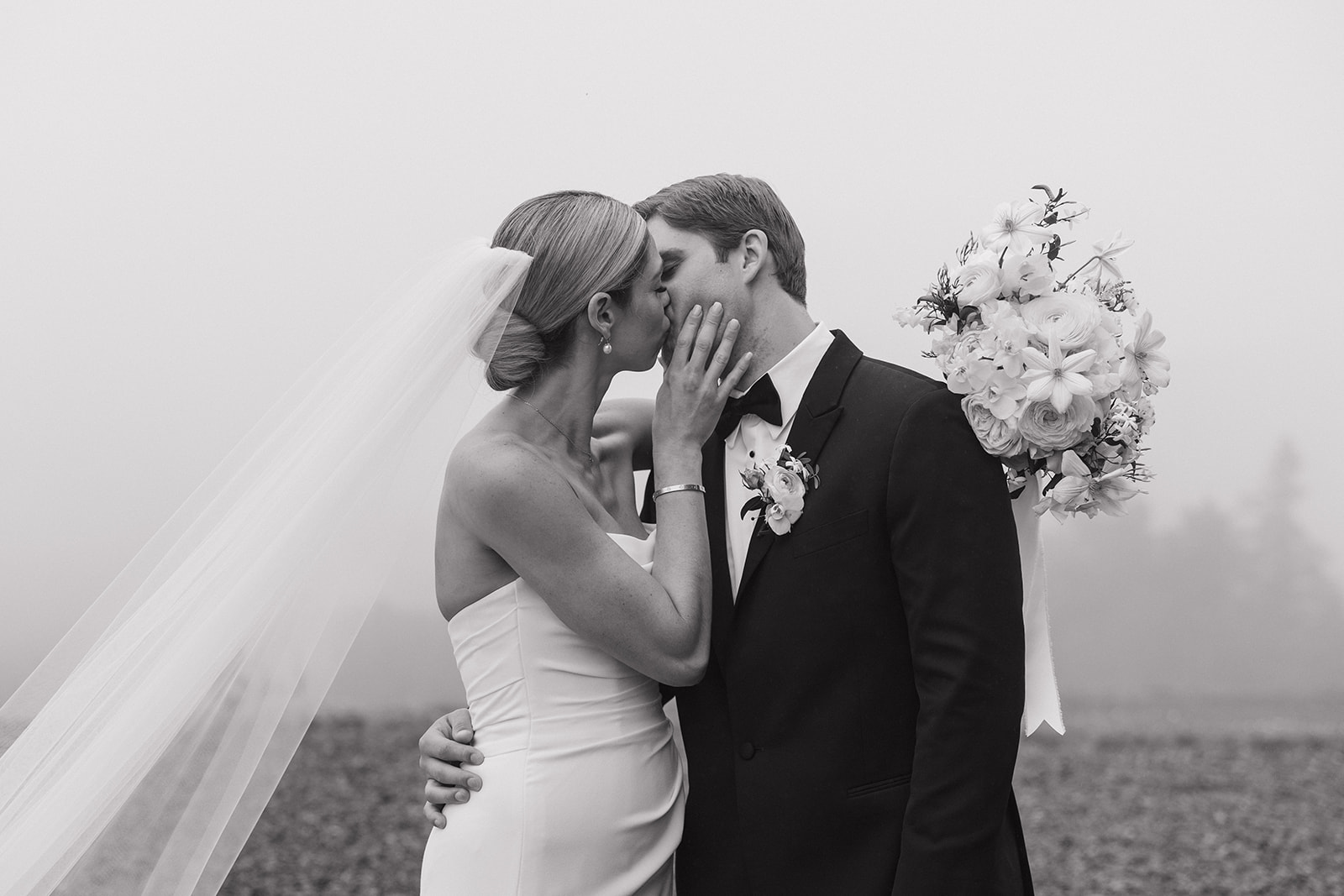 Bride and Groom share a kiss at the top of a mountain in the white mountains of nh 