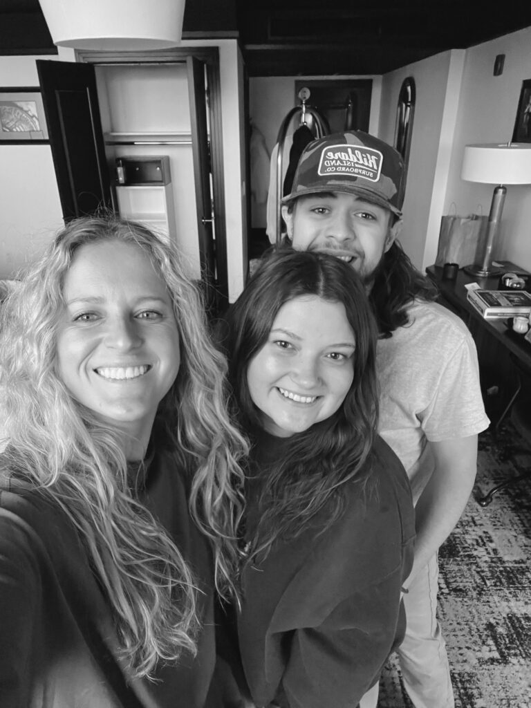 Erica poses for a photo with the new bride and groom