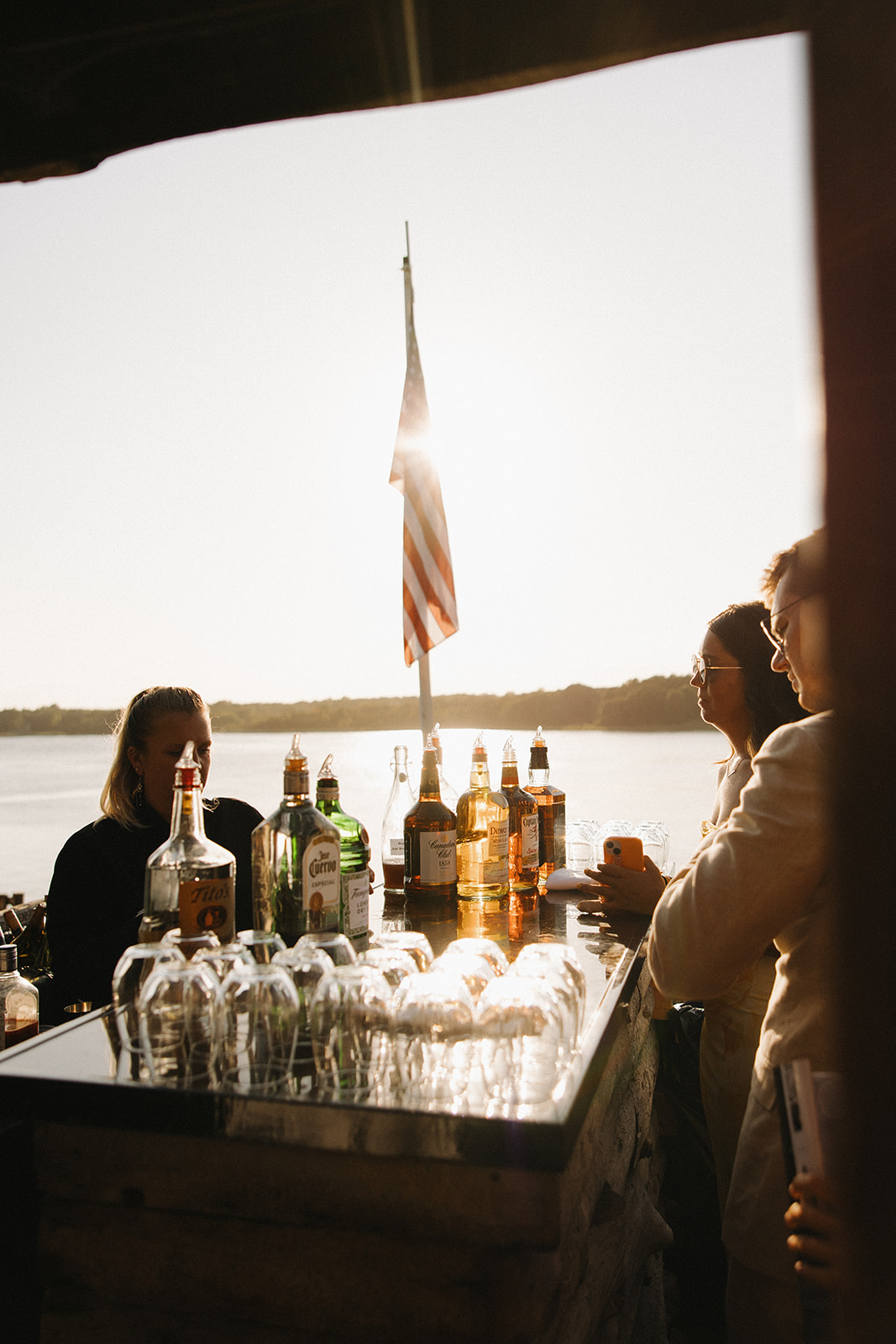 mount hope farm waterfront cocktail hour in golden light photographed by erica warren photography