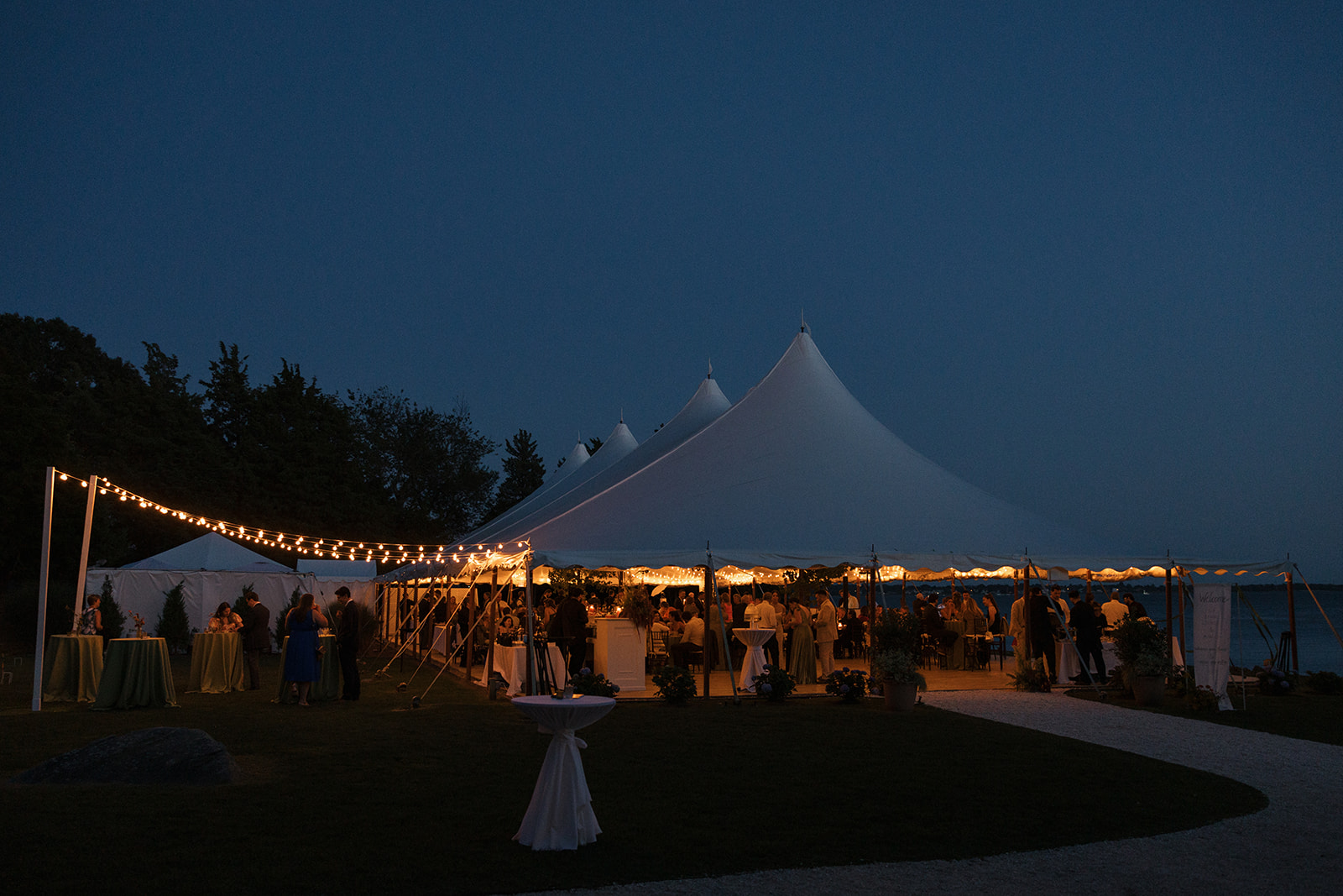 Waterfront tent at dusk at Mount Hope Farm photographed by Erica Warren Photography