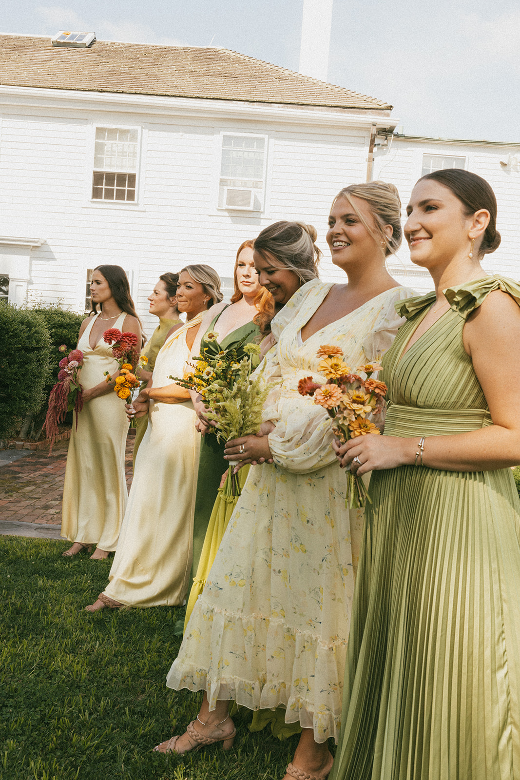 Gorgeous mismatched yellow and green bridesmaid dresses photographed in a documentary style by Erica Warren Photography