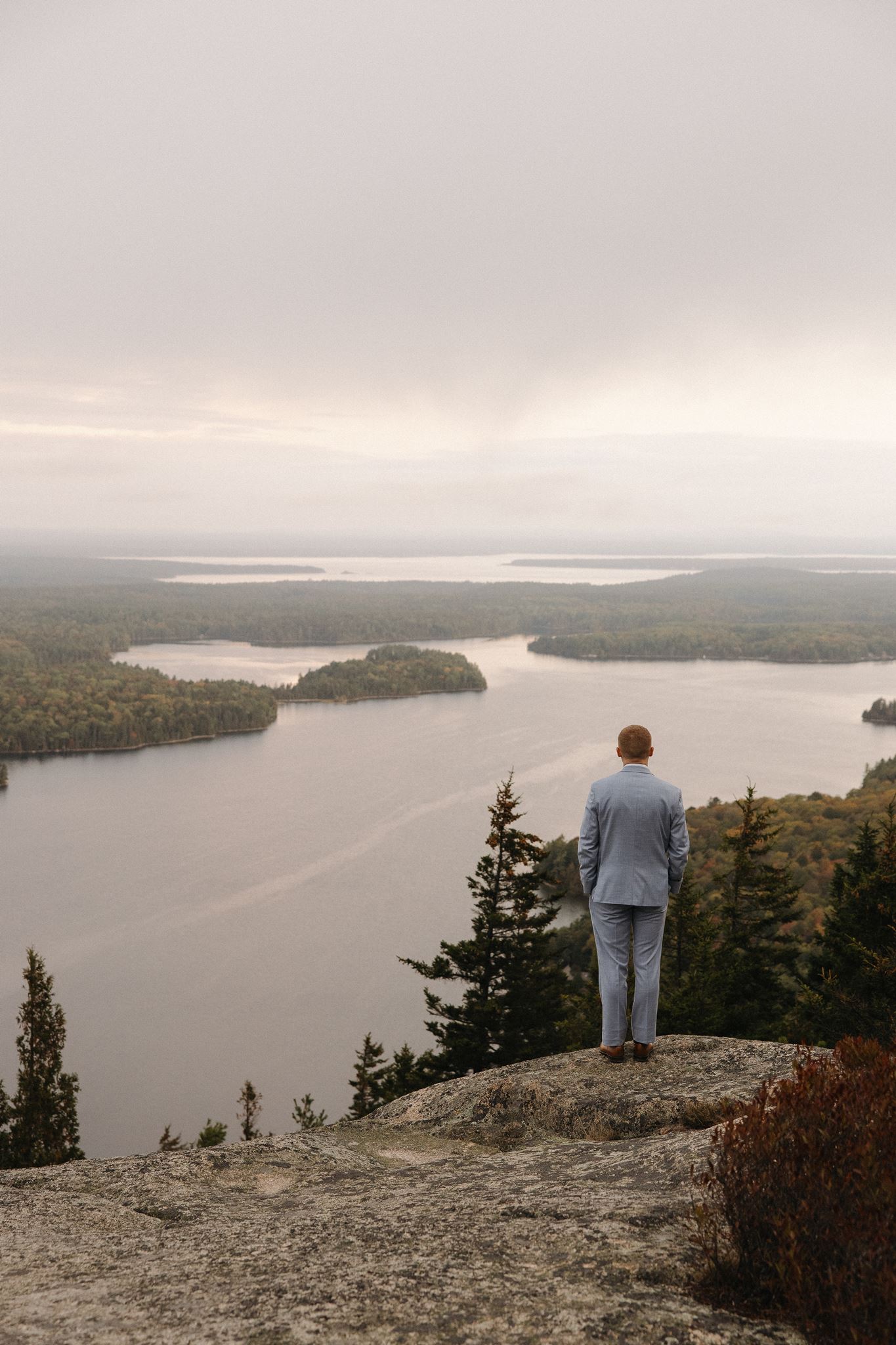 groom looks out over the water