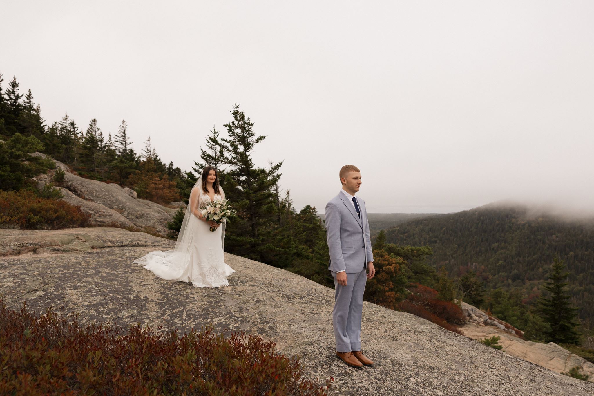 groom looks out at the water during their first look ceremony