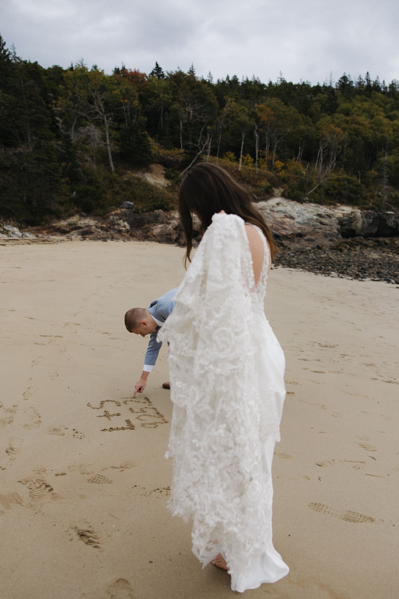 couple share some love with each other on the New England beach
