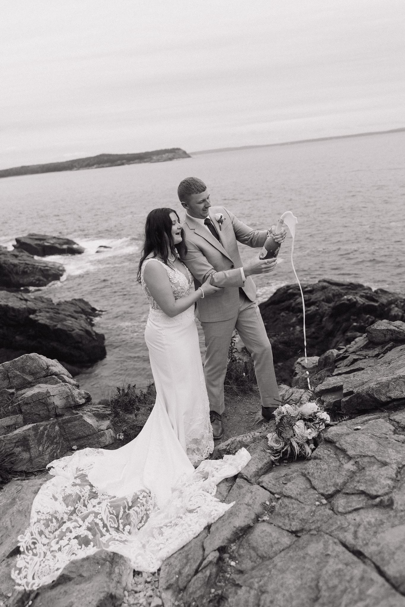 bride and groom perform a champagne pop on the seacoast