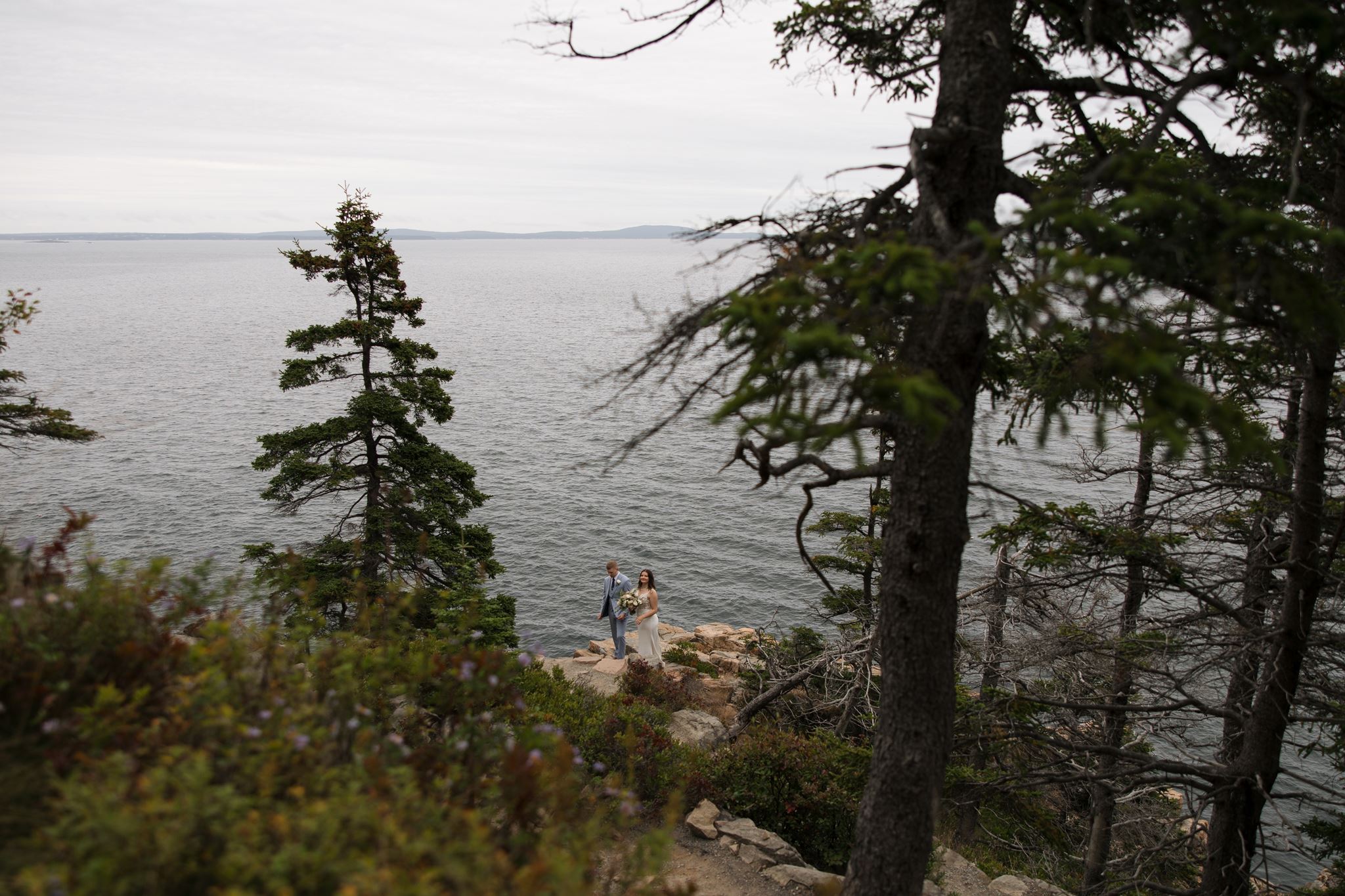 couple pose along the Acadia coastline on their wedding day