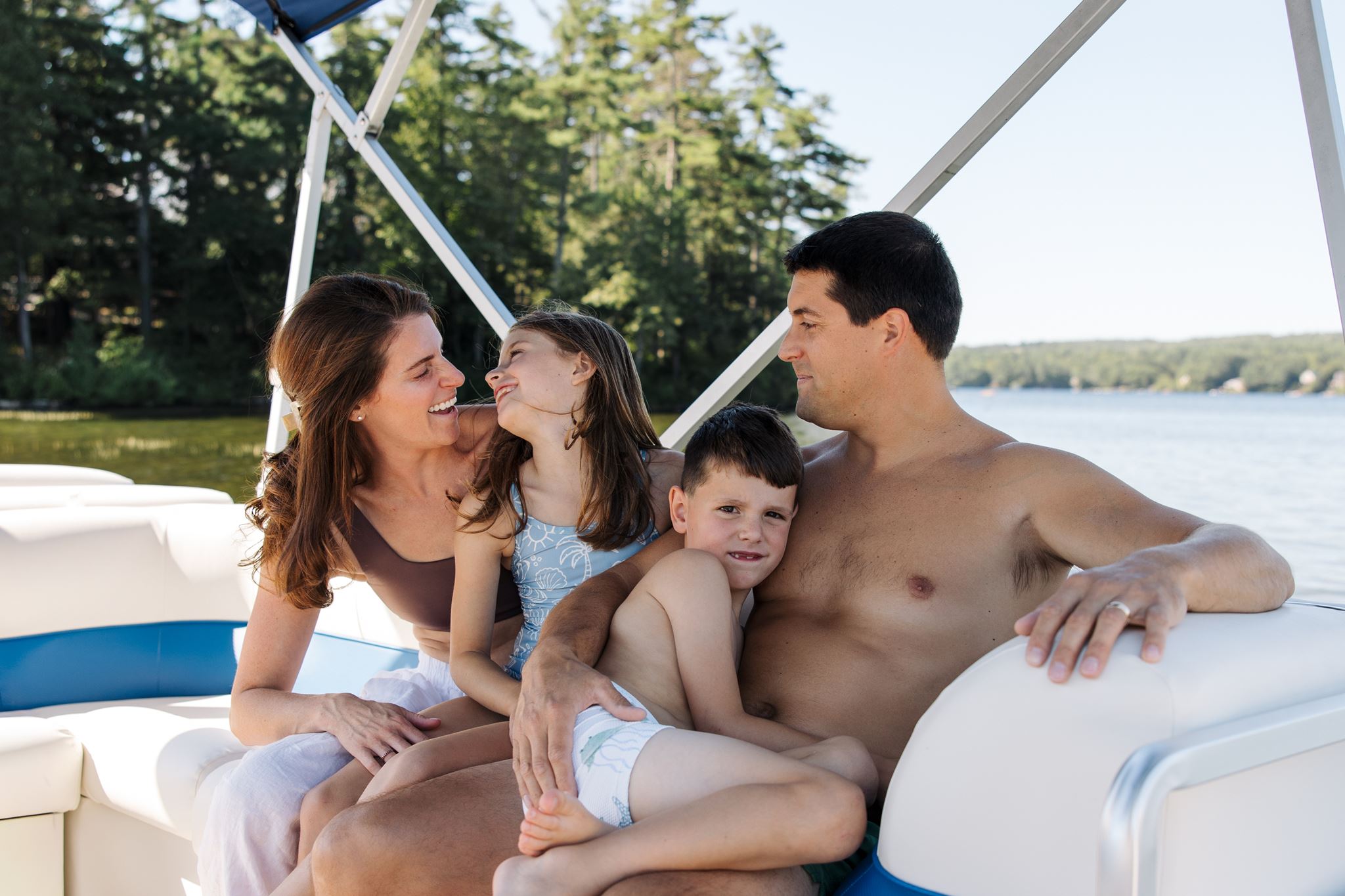 family hangs out on the pontoon as they celebrate together