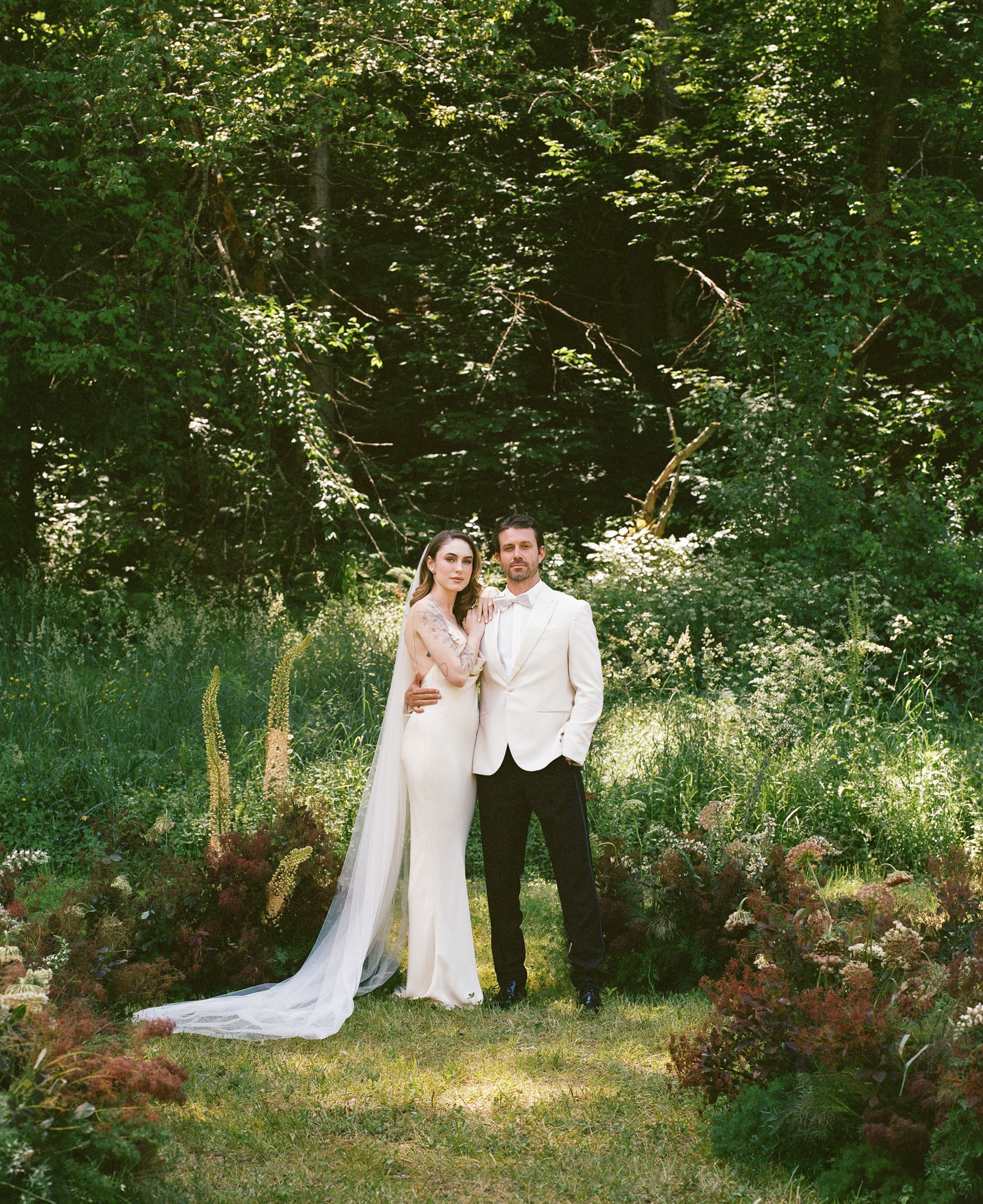 stunning bride and groom pose for a photo after their wedding at of the best vermont wedding venues!