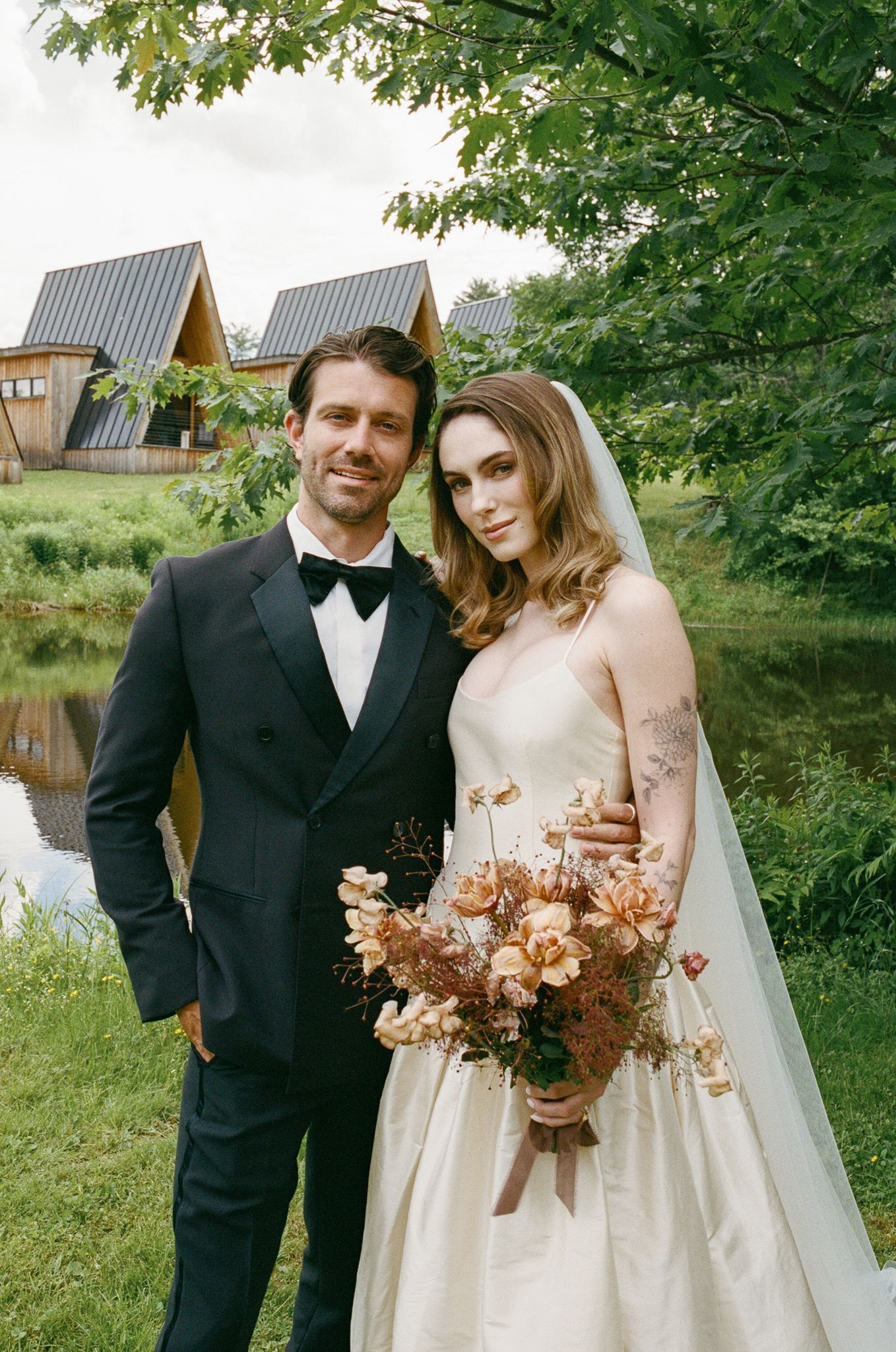 stunning bride and groom pose for a photo after their wedding at of the best vermont wedding venues!