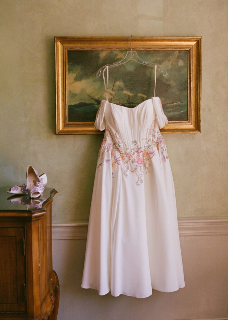 vintage wedding dress hangs from a portrait